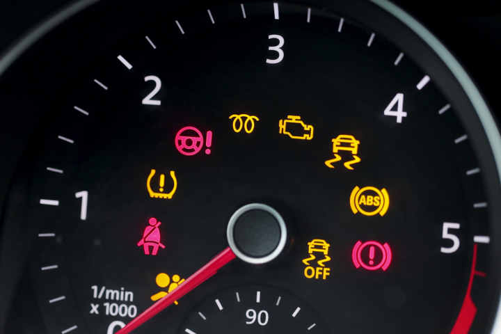 Different car dashboard lights with warning lamps illuminated